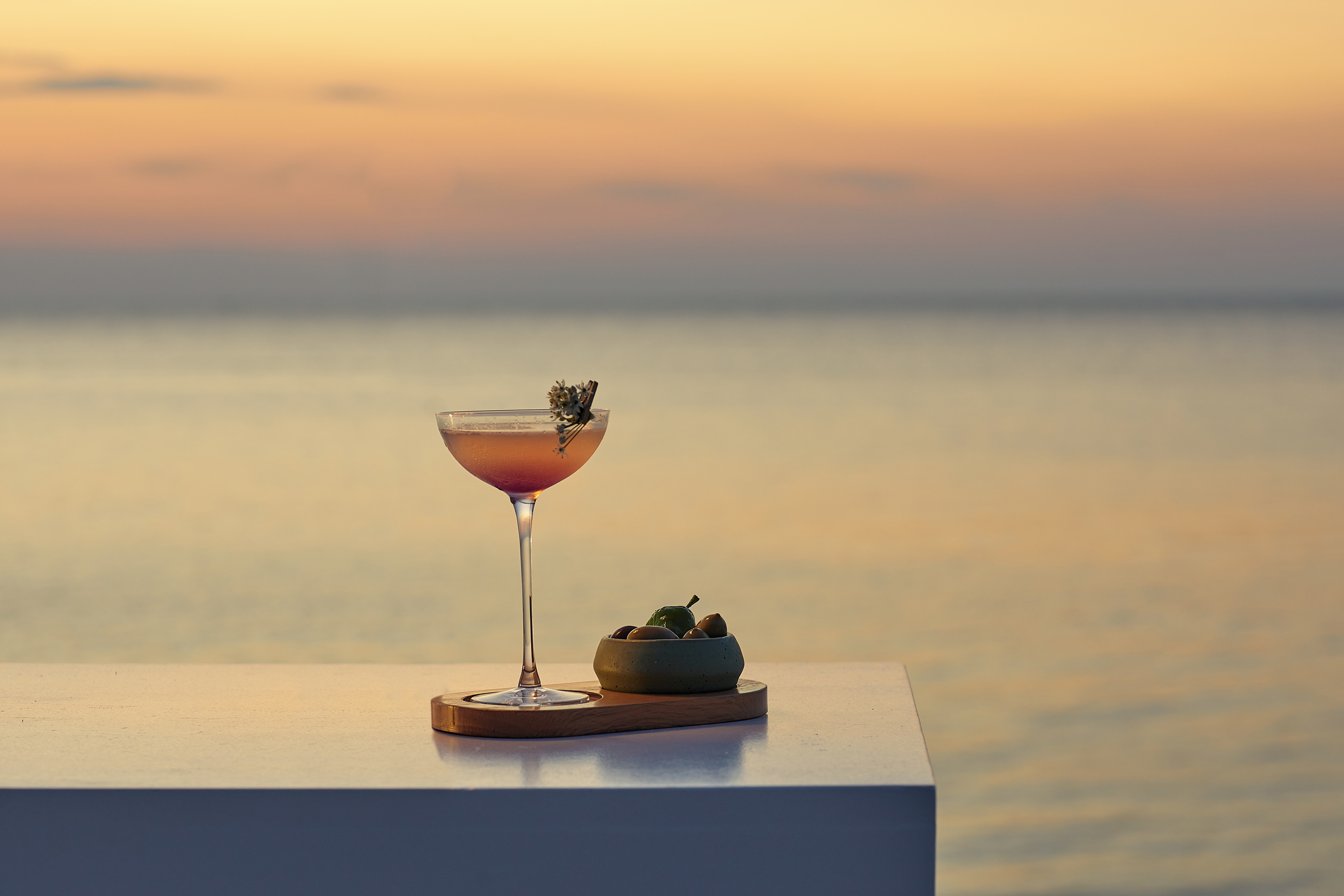 Cocktails next to a lady's hand 