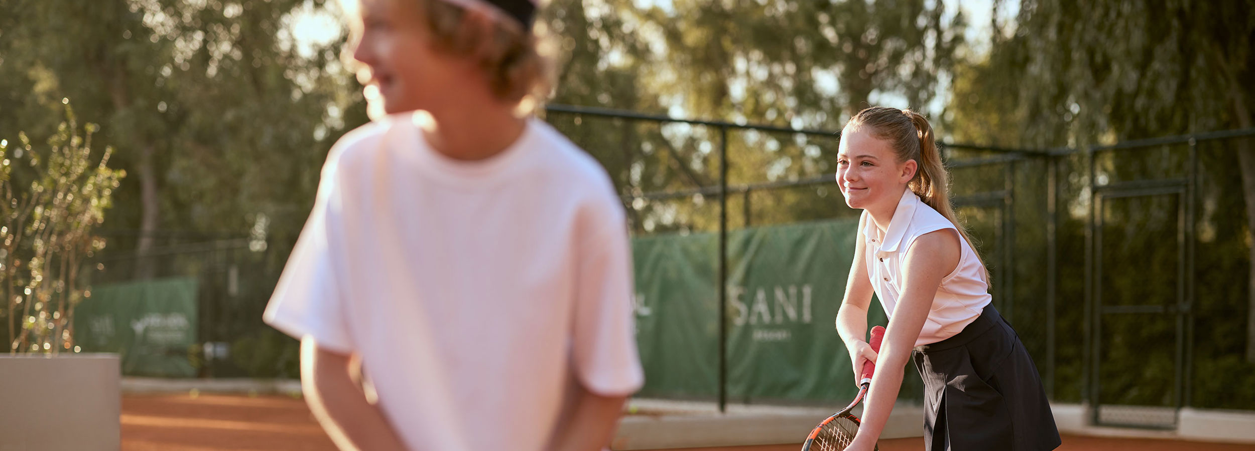 playing tennis at Sani Resort