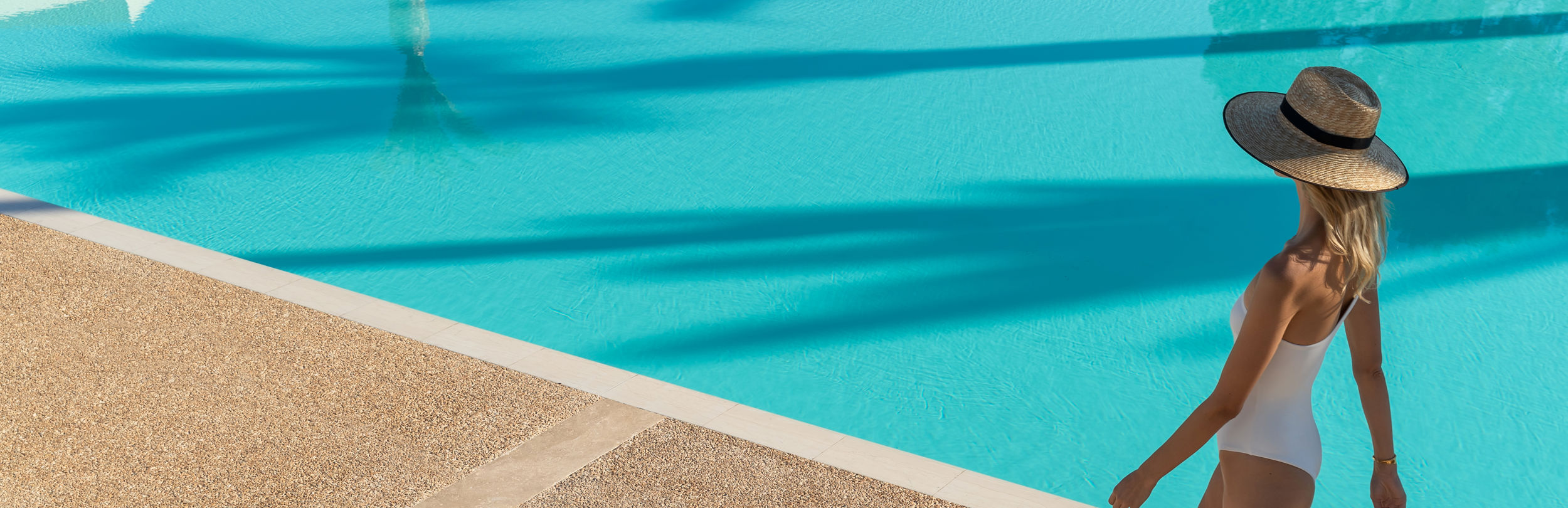 Lady walking around a pool