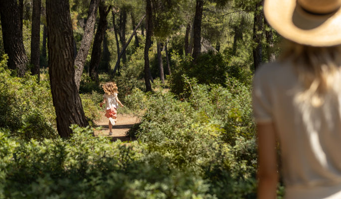 Femme regardant sa fille courir à travers Sani Forest