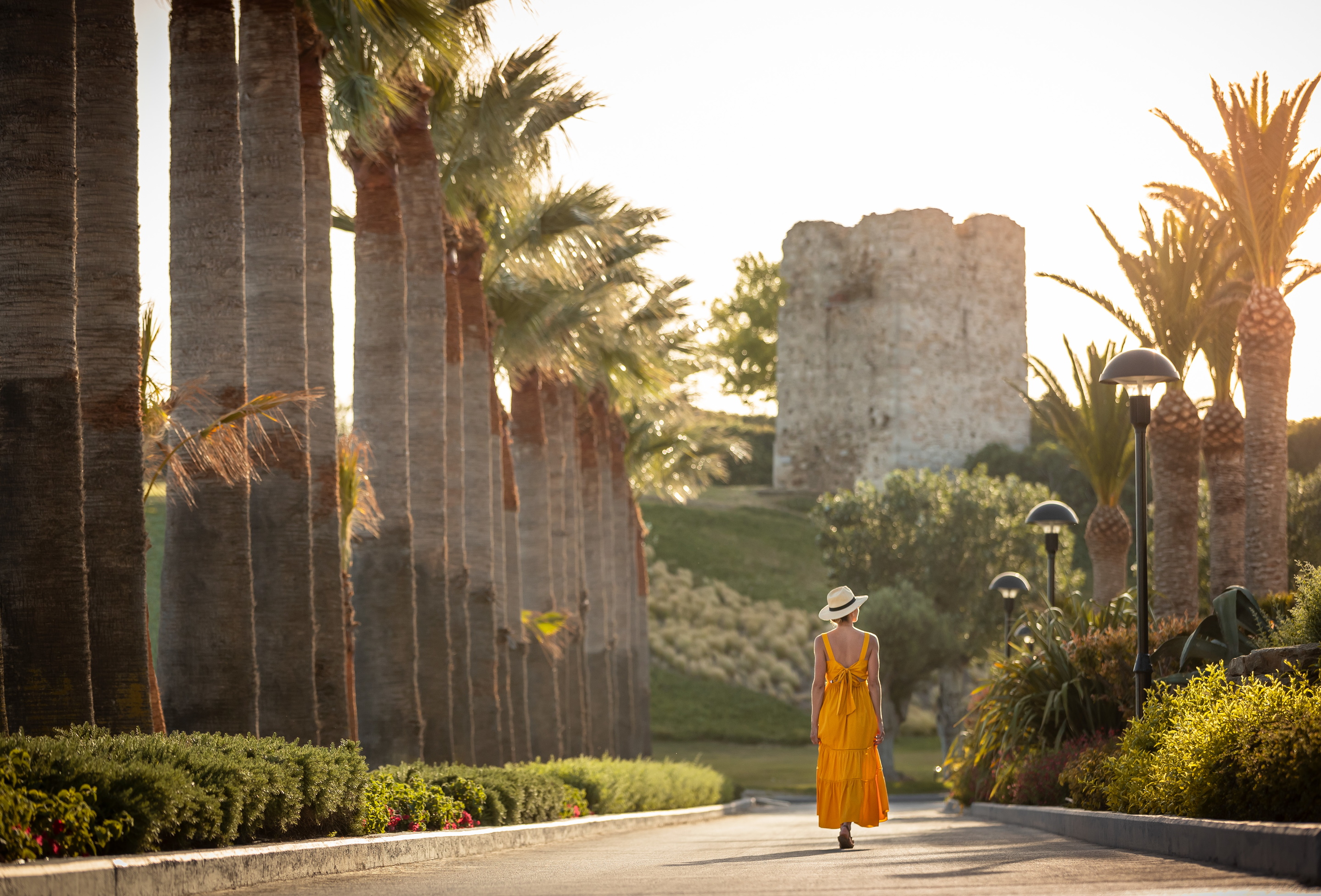 Donna che cammina sul sentiero in cemento al Sani Beach Resort 