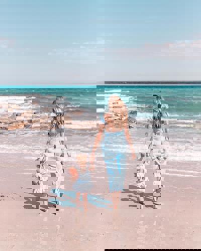 Father and son running in the beach front