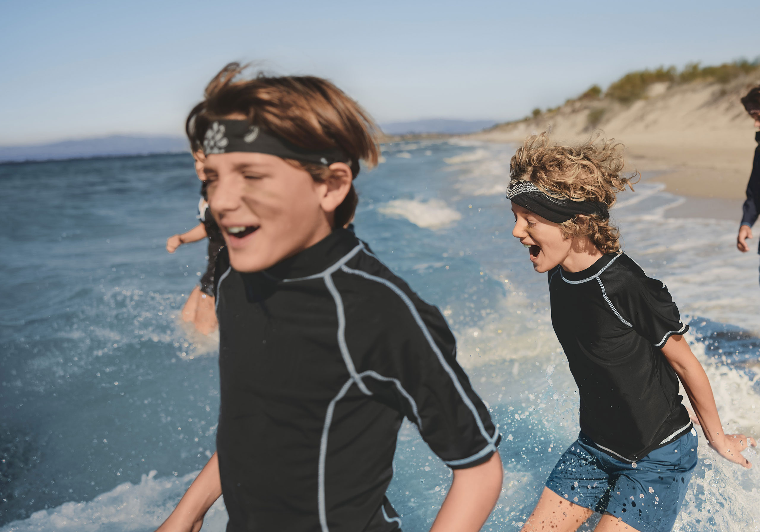 Woman walking next to pool against sea backdrop
