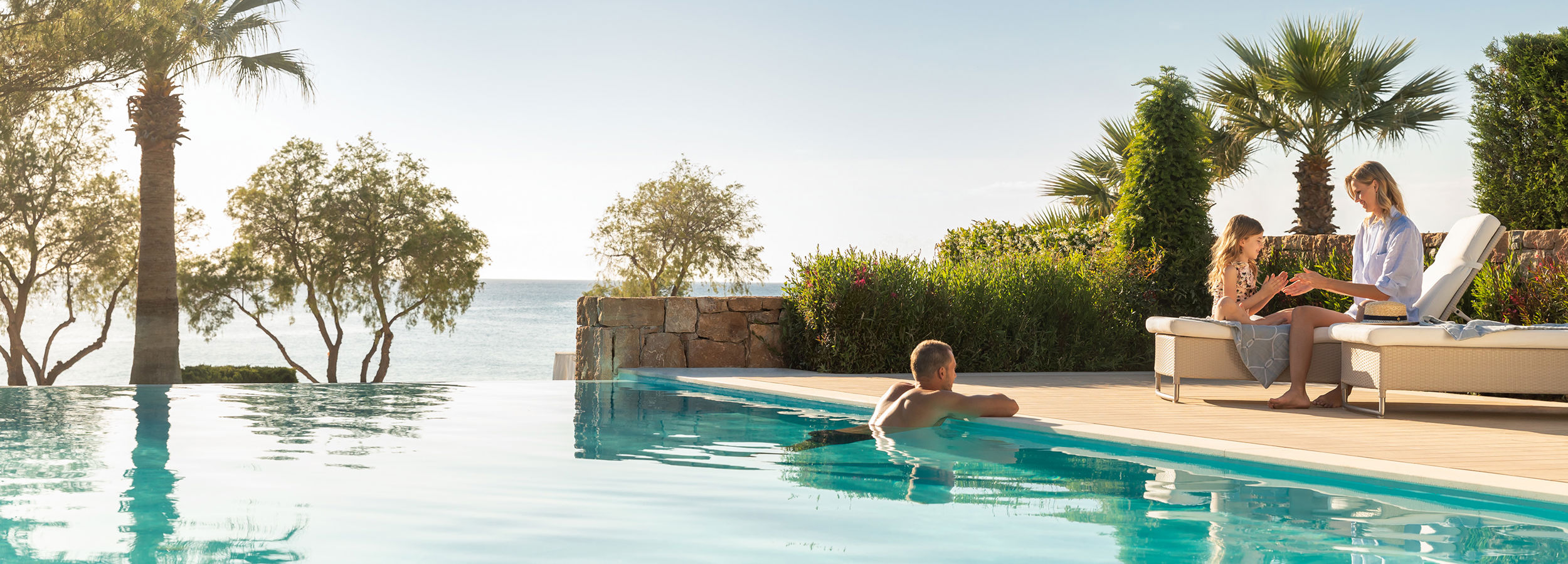 Family relaxing by the pool at Sani Club