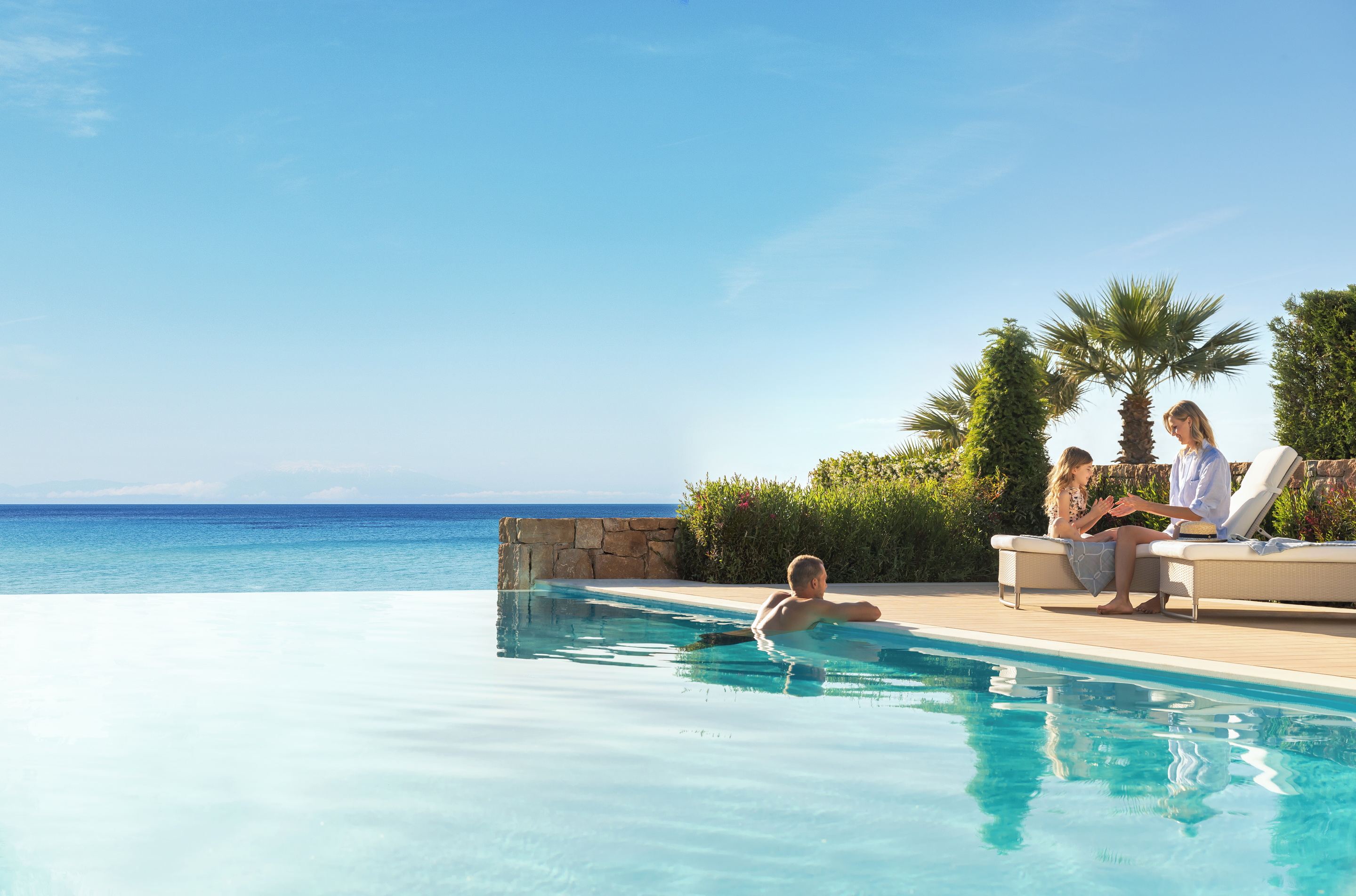 A family enjoying time together at an infinity pool