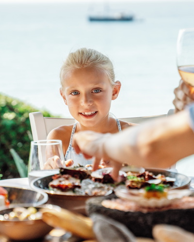 Little girl have dinner with her Family at the Ouzerie Restaurant