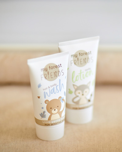 Tubes of baby wash on a changing mat