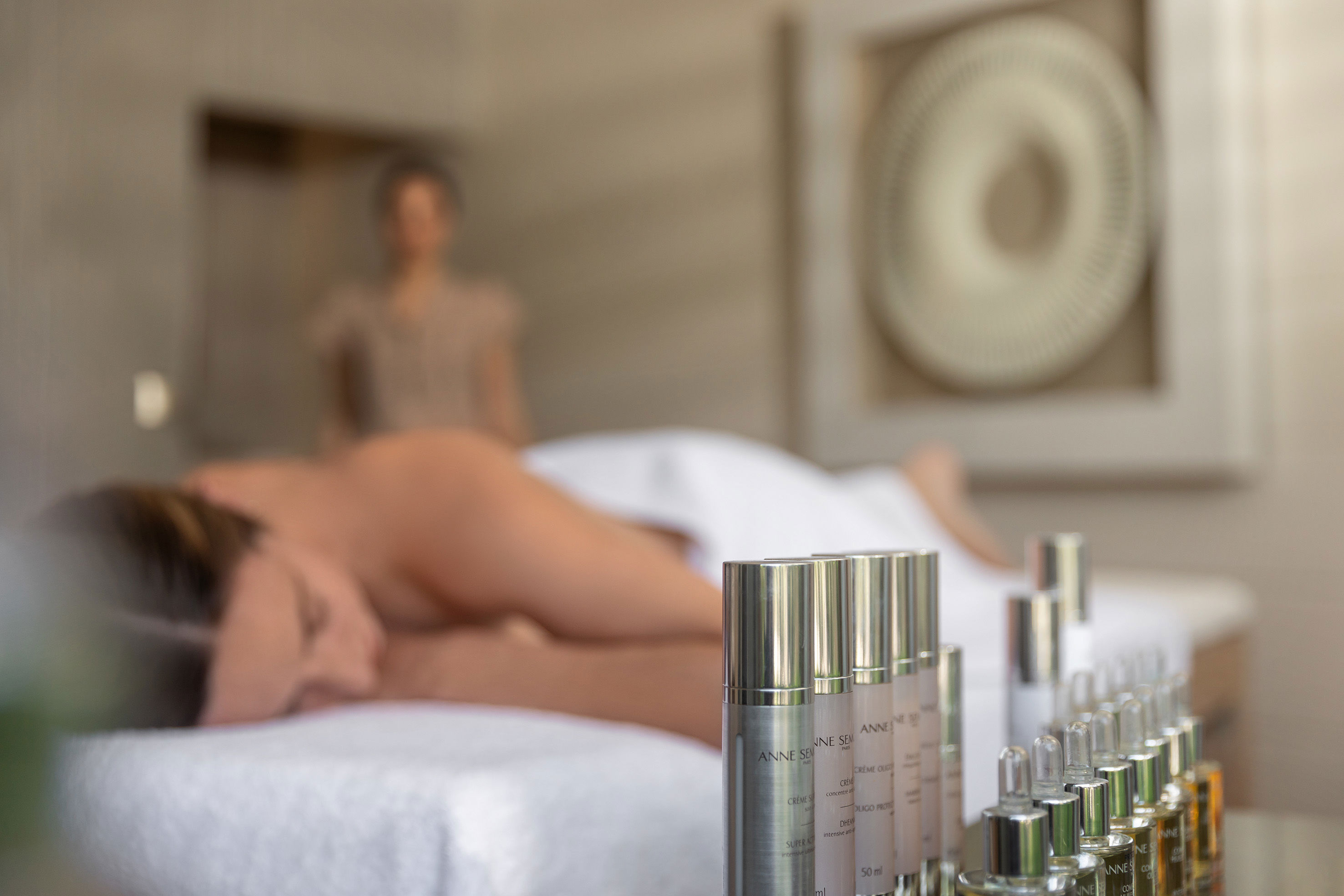 Woman laying down on massage chair at Sani Spa
