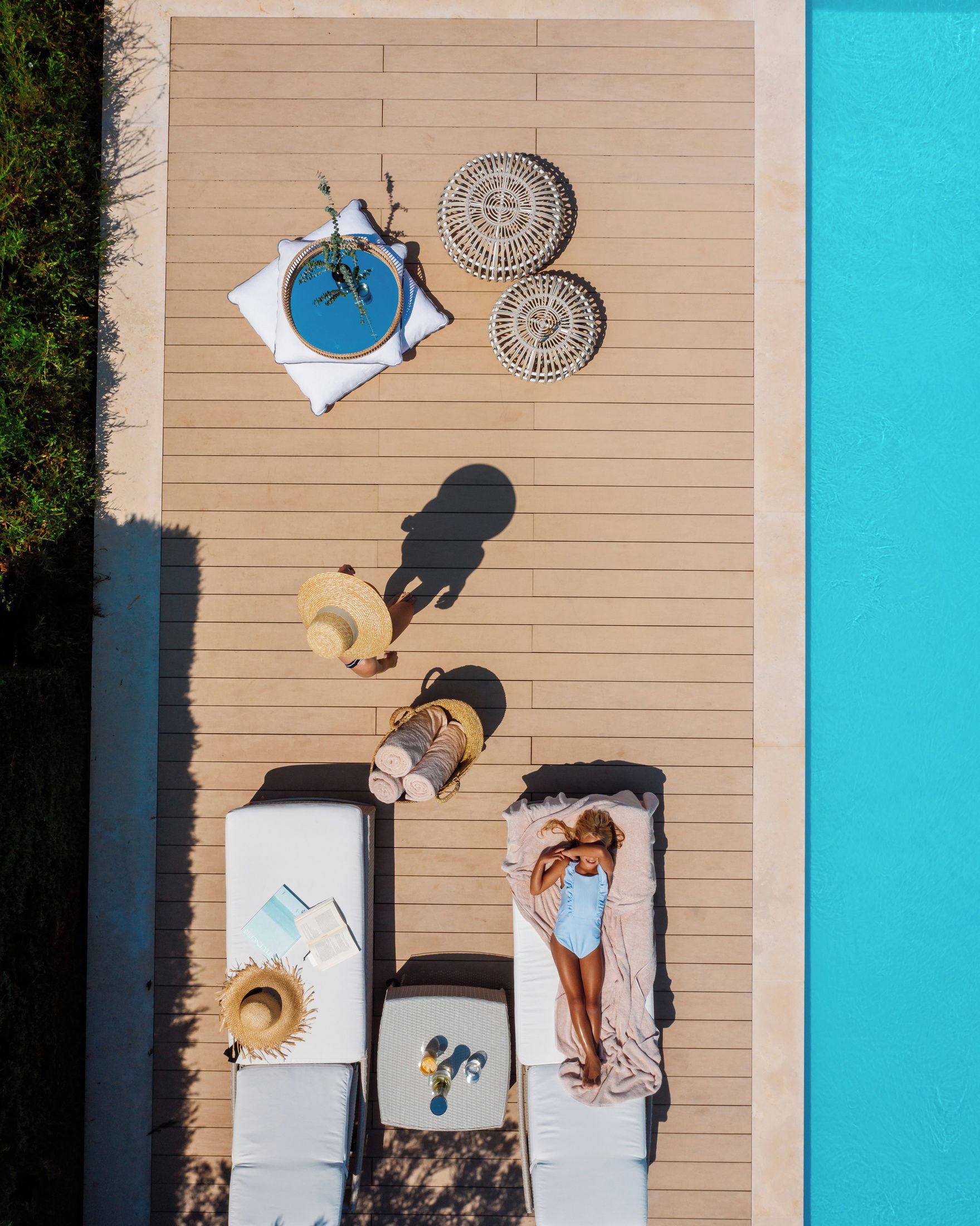 Mother and daughter pool side  with sun loungers